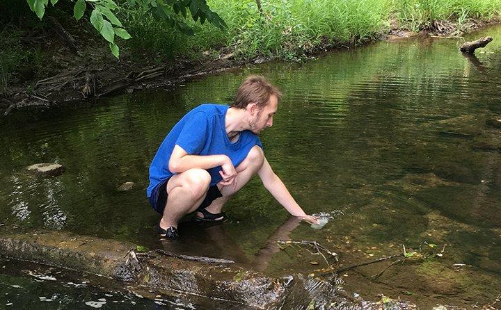 Tylor Mahany ’19 collects water quality samples from the east branch of the Rocky River. Tylor’s data will assist the Richfield Heritage Preserve with monitoring water quality. 